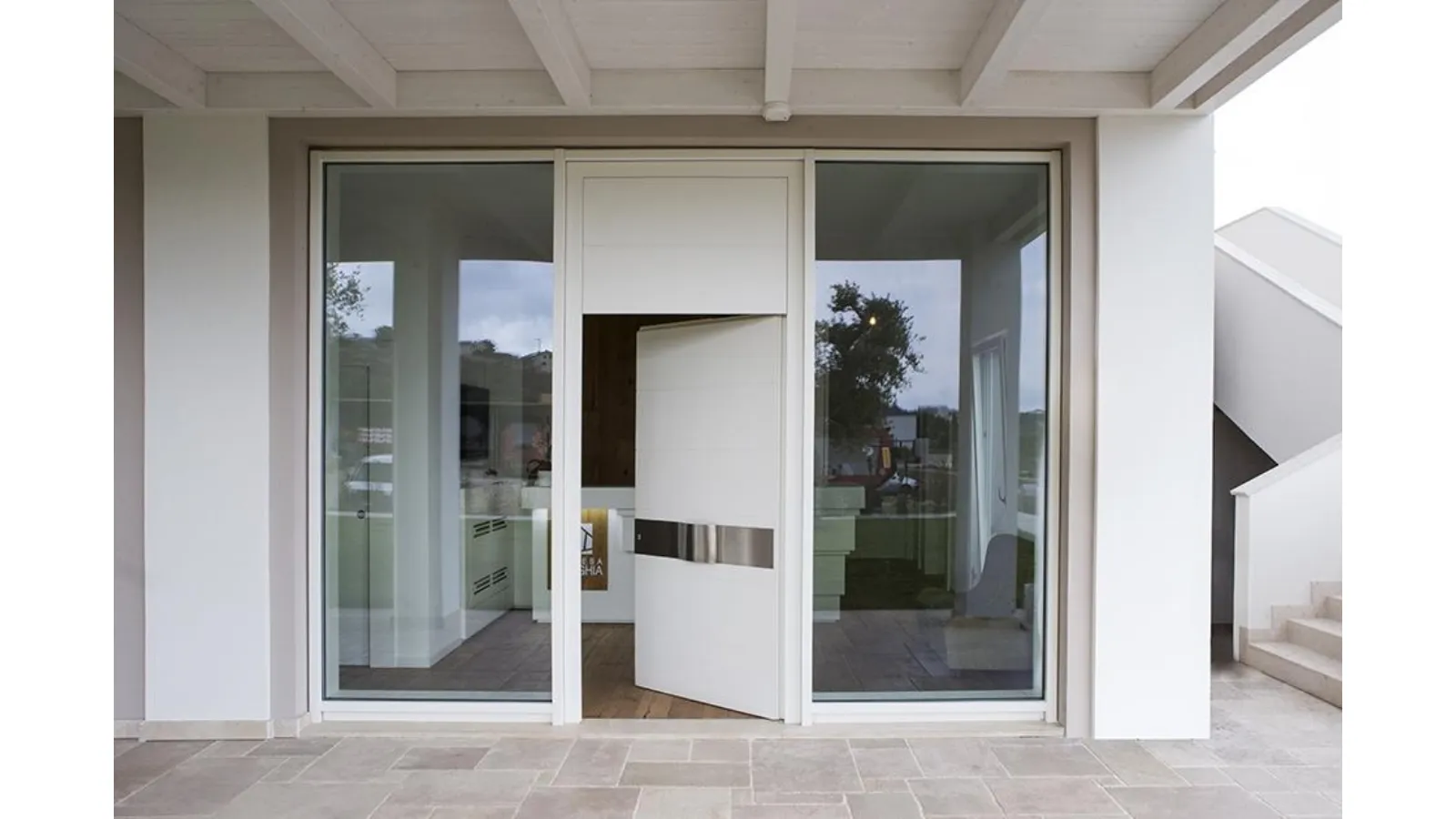 Serramenti fissi in legno e alluminio integrati con portoncino laccato bianco Mix Porte di ingresso e D Wall di De Carlo